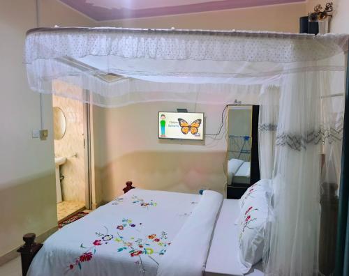 a bedroom with a bed with a canopy at JA Haven Suite in Lira