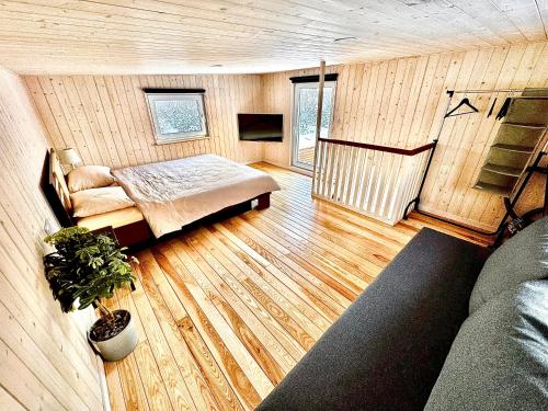 a room with a bed and a couch at Kadaksalu with sauna hinnas in Ruu