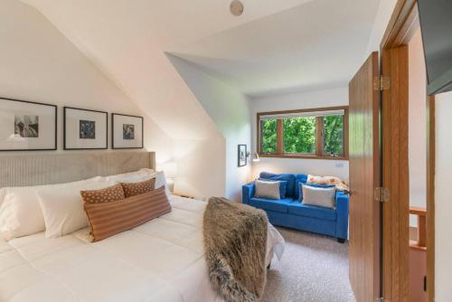 a bedroom with a bed and a blue couch at King Bed Fire Pit Pool & Walk to North Course in Galena