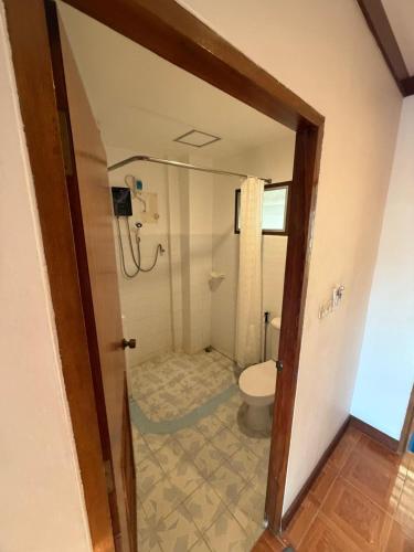 a bathroom with a toilet and a shower at Vibes Solution in Patong Beach