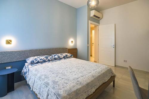 a bedroom with a bed and a table and a door at Donna Maria Apartments - Amami Collection in Amalfi