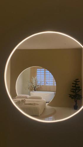 a mirror in a bathroom with two beds and a tub at Ipoh Town Hotel by Serenity in Ipoh