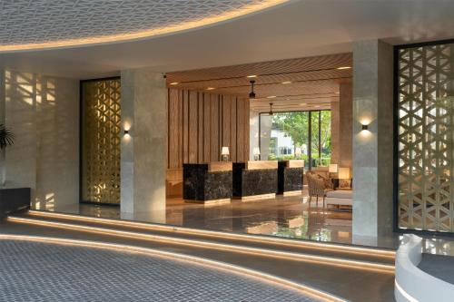a lobby of a hotel with a reception desk at Radisson Blu Resort, Phuket Mai Khao Beach in Mai Khao Beach