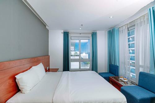 a hotel room with a bed and a window at Rico hotel Nha Trang in Nha Trang