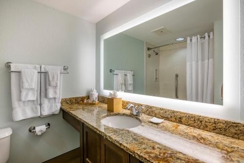a bathroom with a sink and a large mirror at Bluegreen Vacations Hammocks at Marathon, Ascend Collection Resort in Marathon