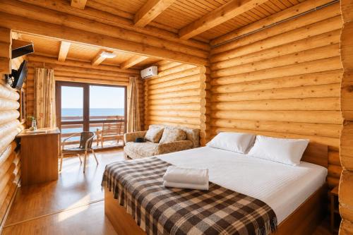 a bedroom with a bed and a table with a chair at Ensenada in Gribovka