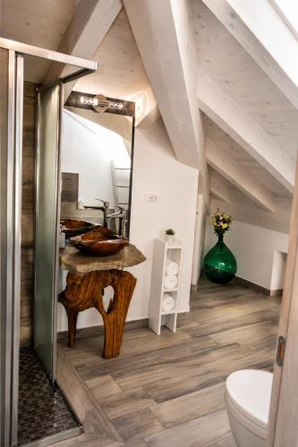 a bathroom with a wooden table and a mirror at White suite - Jacuzzi, Swimming pool & Lake view in Lezzeno