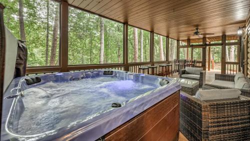 a jacuzzi tub in a room with trees at Among the Trees in Epworth