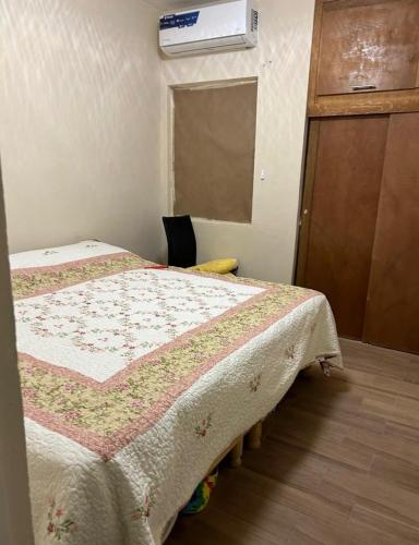 a bedroom with a bed with a quilt on it at Excente alojamiento in Zaragoza