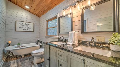 a bathroom with two sinks and a tub and a toilet at Love Affair in Epworth