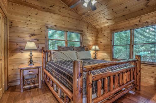 a bedroom with a bed in a log cabin at Black Bear Lodge in Blue Ridge