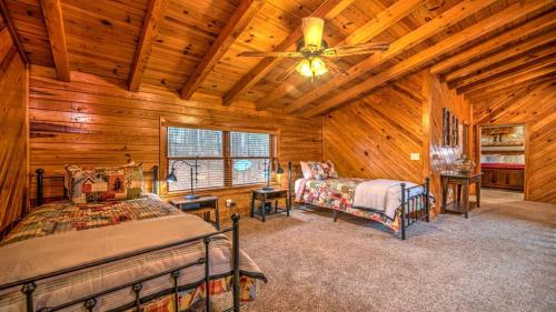a bedroom with two beds and a ceiling fan at Falling Waters in Blue Ridge