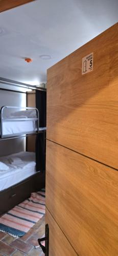 a wooden dresser in a room with a drawer at Havana Hostel in Albufeira