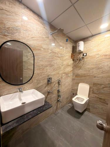 a bathroom with a sink and a toilet at Hotel Fortune, Althan in Surat