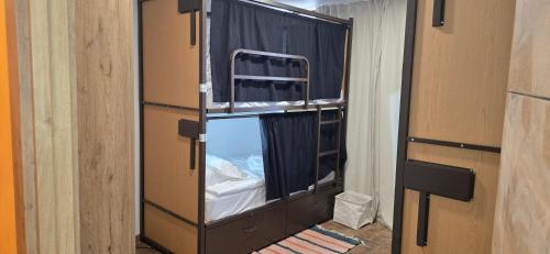 a room with two bunk beds with a window at Havana Hostel in Albufeira