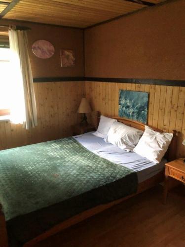 a bedroom with a large bed with white pillows at cozy alpine house in Breitenstein
