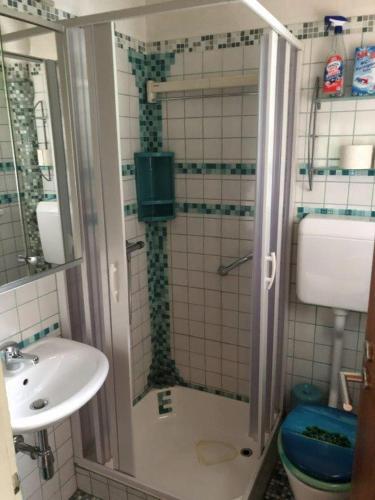 a small bathroom with a shower and a sink at cozy alpine house in Breitenstein