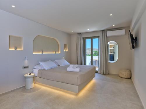 a bedroom with a bed and a large window at Kali Naousa in Naousa