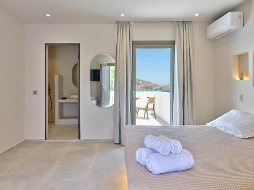 a bedroom with a bed with towels on it at Kali Naousa in Naousa