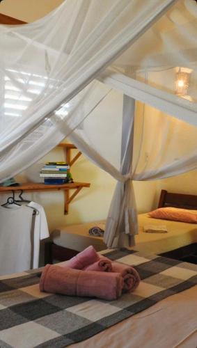 a bedroom with a bed with a canopy at Villa Cajuiero Inn in Prea