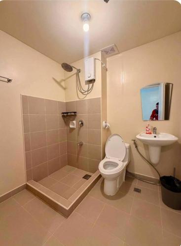 a bathroom with a shower and a toilet and a sink at Avida Towers Riala Tower 1 in Cebu City