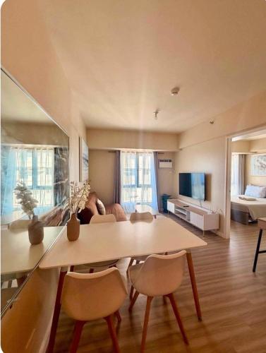 a living room with a table and chairs and a couch at Avida Towers Riala Tower 1 in Cebu City