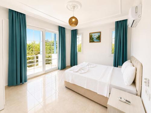 a bedroom with a bed and a large window at Villa Fergana in Oludeniz