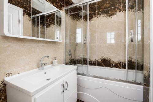 a bathroom with a white sink and a shower at Villa Fergana in Oludeniz