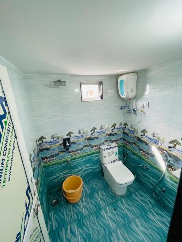 a bathroom with a toilet and a sink in it at Hotel sagar inn in Ajmer