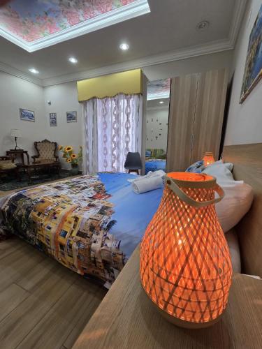 a bedroom with a bed with a basket on a table at Maison de Ciro in Gragnano