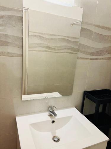 a bathroom with a white sink and a mirror at Casa dos Tios- Estremoz in Estremoz