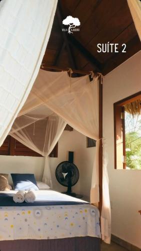 a bedroom with a bed with a canopy at Villa Cajuiero Inn in Prea