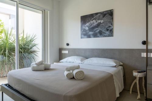 a bedroom with a large bed with towels on it at Sublimare Luxury Apartments in Giulianova