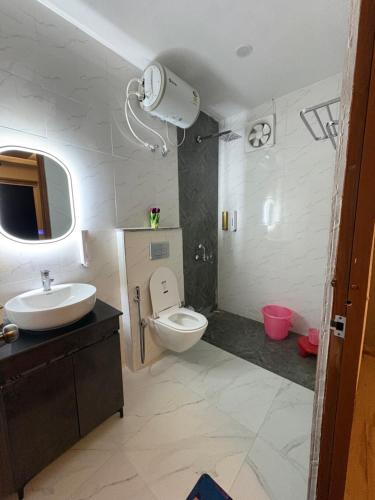 a bathroom with a toilet and a sink at La Vida Estate Farm in Garhmuktesar