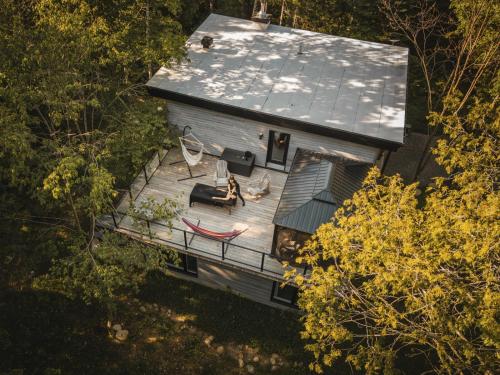 an overhead view of a house with a deck at Chalet la coulée douce, Expérience thermale privée in Saint Come