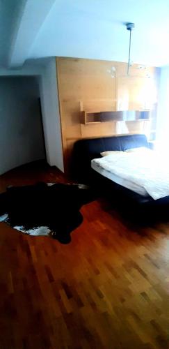 a bedroom with two beds and a wooden floor at Holiday Home in Gevgelija