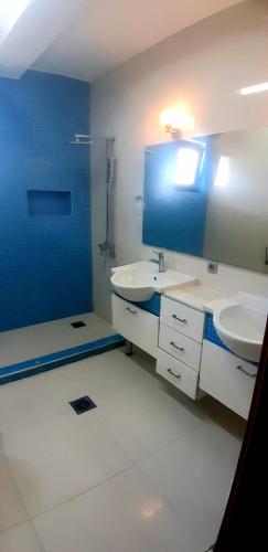a bathroom with two sinks and a blue wall at Holiday Home in Gevgelija