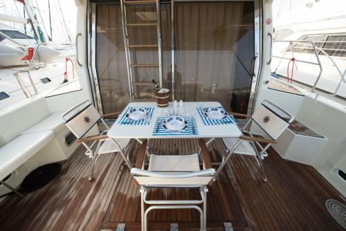 a table and chairs sitting on the deck of a boat at Solymar Greece Yachting. m/y "LL" in Athens