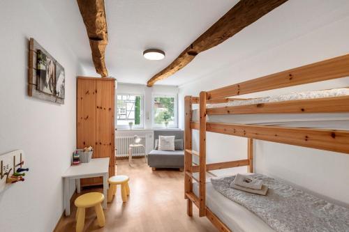 a room with two bunk beds and a desk at Ferienhof Riekeshof in Schmallenberg