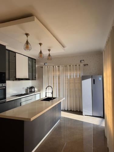 a kitchen with a white refrigerator and a counter at MAI instahomes in Lilongwe