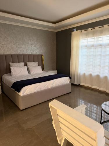 a bedroom with a large bed and a window at MAI instahomes in Lilongwe