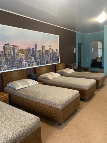 four beds in a room with a city view at Ночівля in Poltava