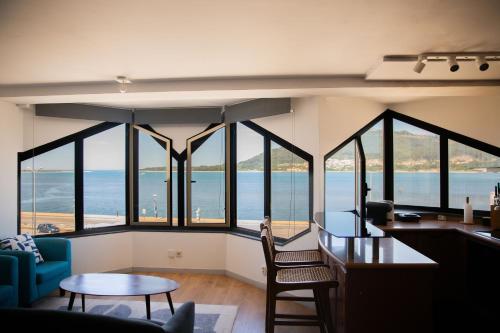 a living room with a view of the ocean at Just Like Home - Blue River in Caminha