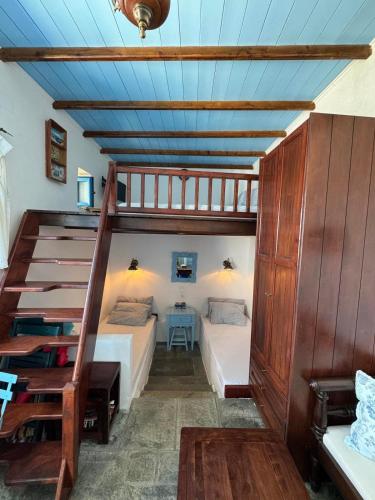 a bedroom with a bunk bed and a staircase at John's View in Serifos Chora