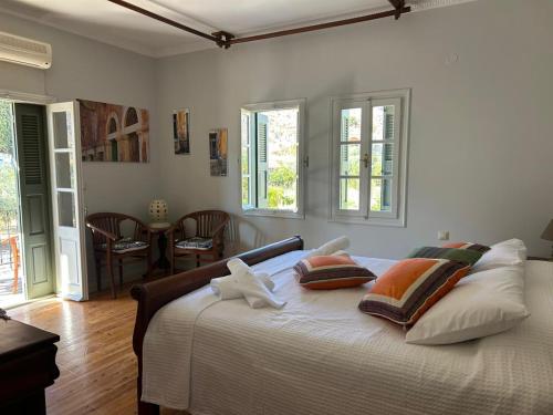 a bedroom with a large white bed with two pillows at Villa To Petrino in Vathís
