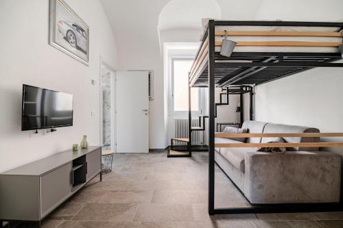 a living room with a bunk bed and a television at Ca del Lac, few steps from Lake Maggiore in Porto Valtravaglia