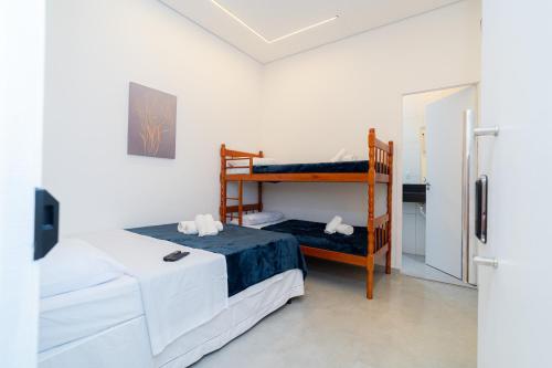 a bedroom with two beds and a bunk bed at Airport Hotel Gru in Guarulhos