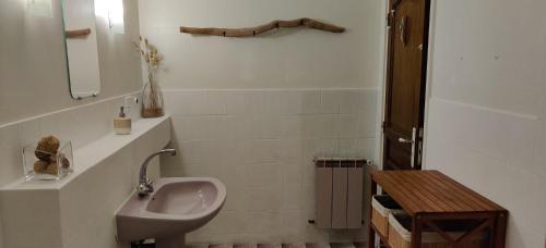 a white bathroom with a sink and a mirror at Maison au bord de dune et océan in Labenne