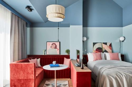 a bedroom with a bed and a red couch at Schwan Locke in Munich