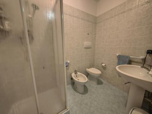 a bathroom with a shower and a toilet and a sink at Sunset Garden Sanremo in Sanremo